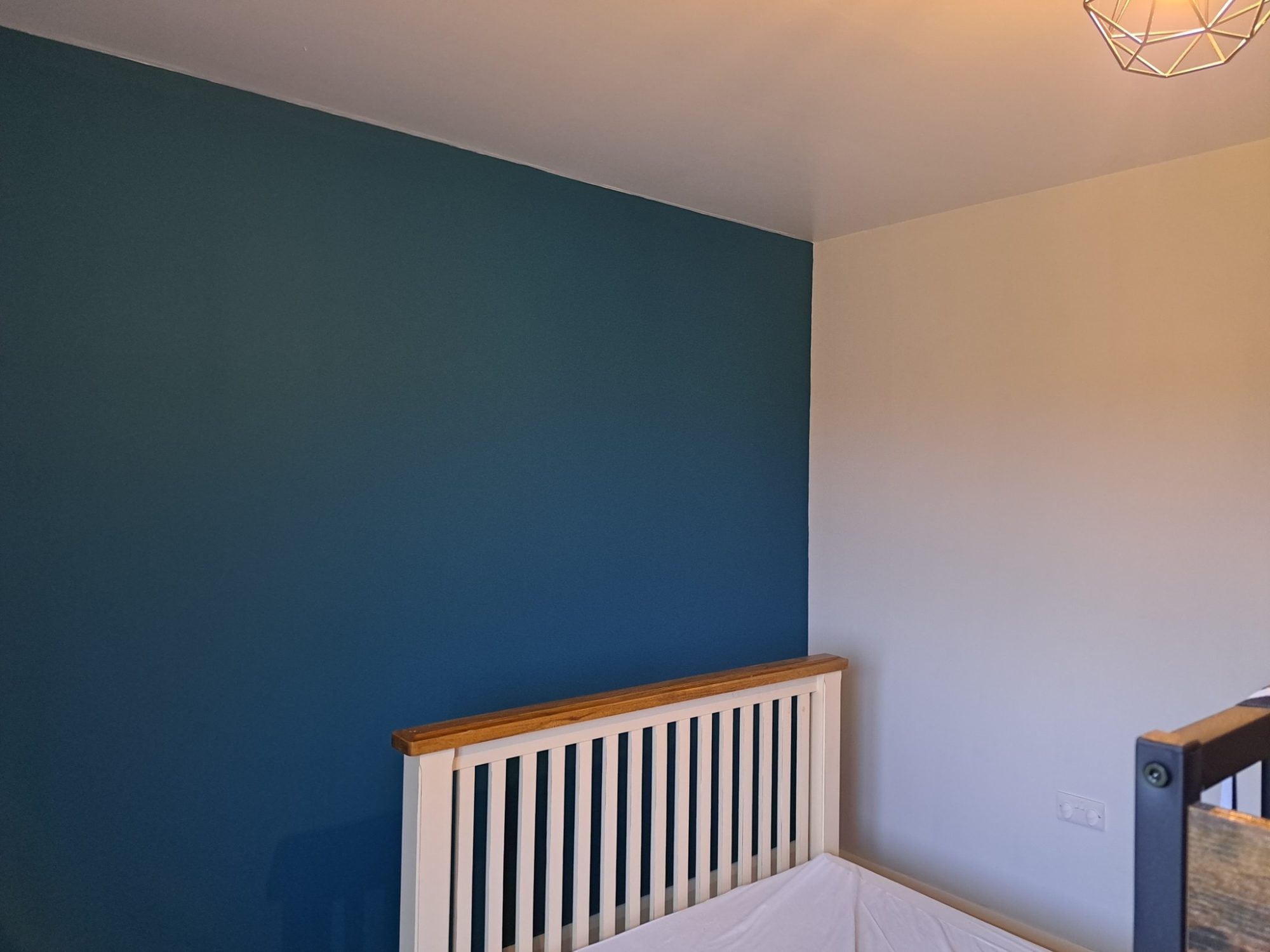 Blue feature wall in a bedroom